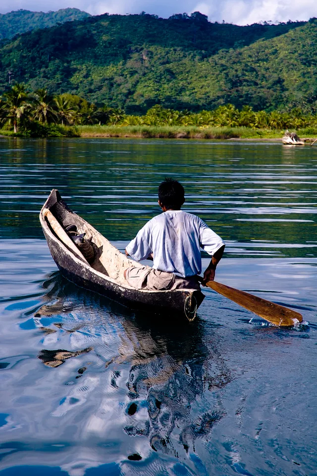 A fisher paddling a dugout canoe in Kuna Yala