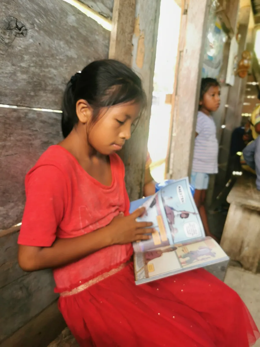 A girl reading the Martina book